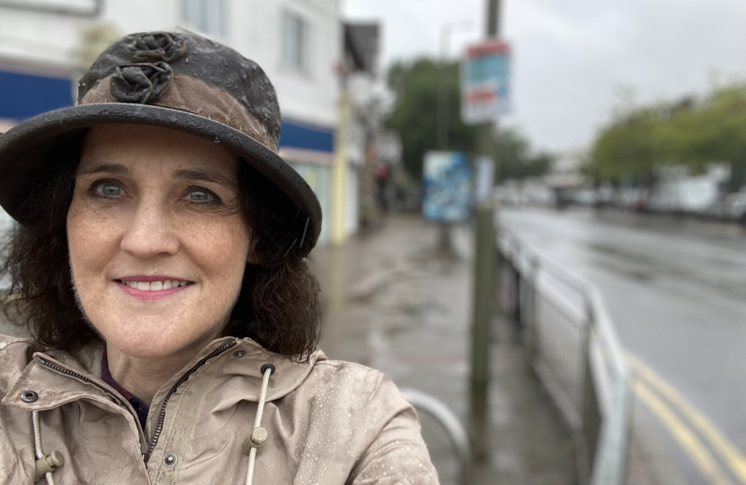 Theresa Villiers MP in the rain in New Barnet