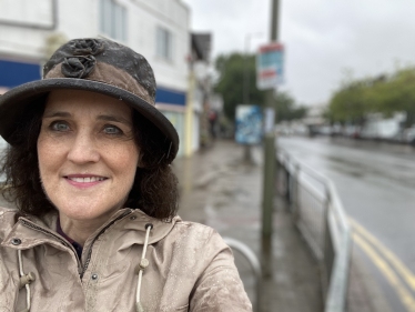 Theresa Villiers MP in the rain in New Barnet