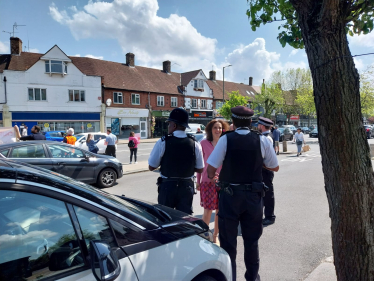 Theresa Villiers MP talking to police officers in New Barnet